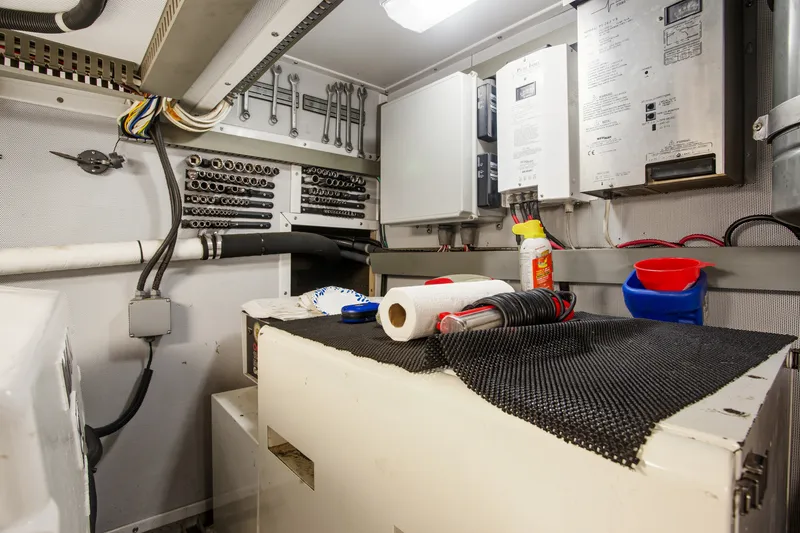 Slide: The Image of Engine room of 1993 Johnson 56 Motor Yacht with tools and equipment. - 42