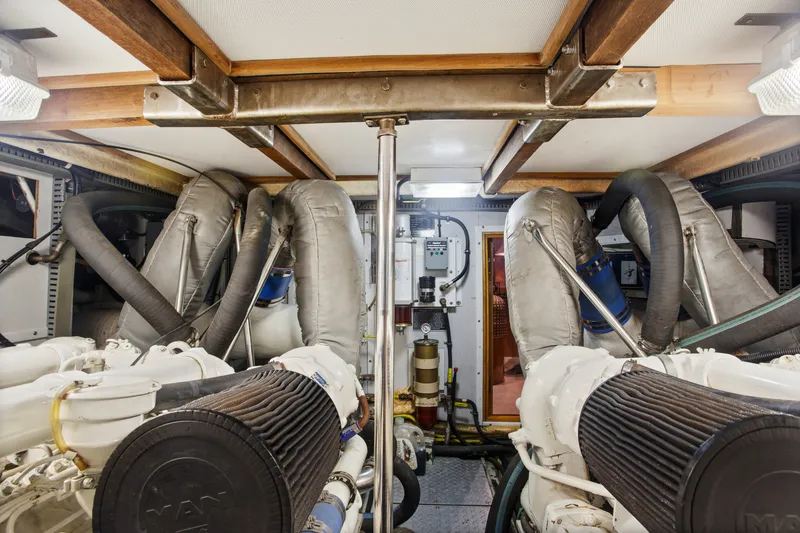 Slide: The Image of Engine room of a 1993 Johnson 56 Motor Yacht, showcasing dual engines and mechanical systems. - 44