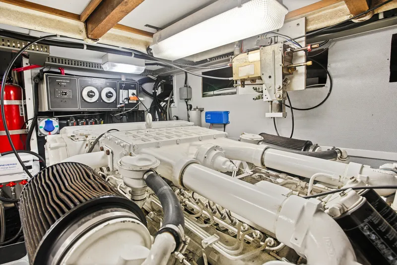 Slide: The Image of Engine room of a 1993 Johnson 56 Motor Yacht, featuring mechanical components and control panels. - 38