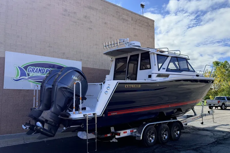 Slide: The Image of 2027 Cutwater C-288 Coupe boat on trailer, parked outside Grand Pointe Marine. - 1