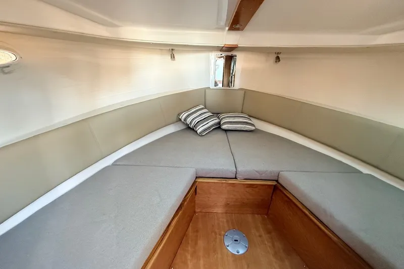 Slide: The Image of 2027 Cutwater C-288 Coupe interior cabin with cozy seating and striped pillows. - 18