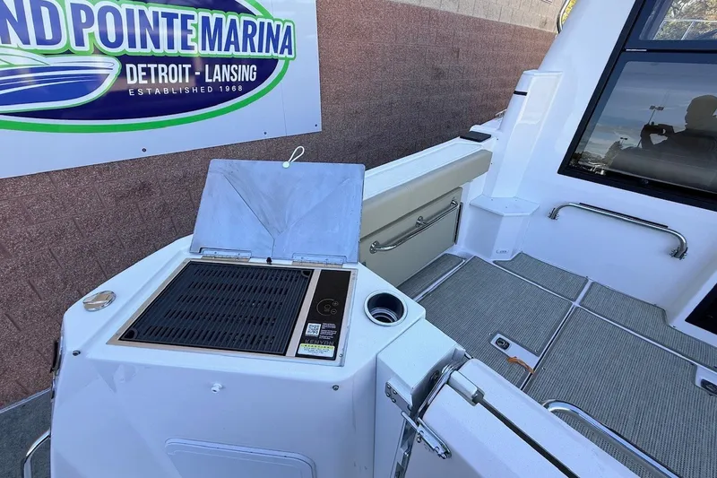 Slide: The Image of 2027 Cutwater C-288 Coupe boat interior with grill at Island Pointe Marina. - 6