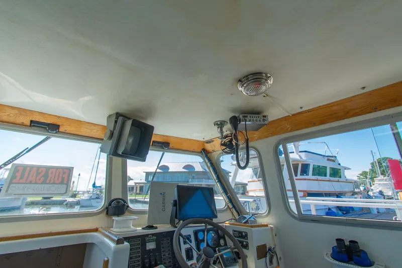 Slide: The Image of Interior of 2002 Donelle Express Down East Lobster Boat with navigation equipment and "For Sale" sign. - 10