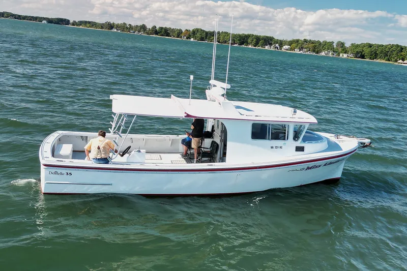 Slide: The Image of 2002 Donelle Express Down East Lobster Boat cruising on a scenic lake. - 30