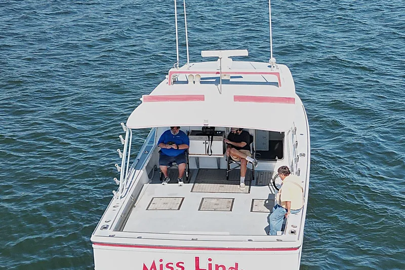 Slide: The Image of 2002 Donelle Express Down East Lobster Boat on water with three people aboard. - 34