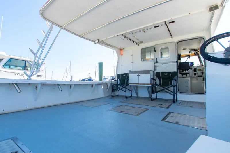 Slide: The Image of 2002 Donelle Express Down East Lobster Boat interior with seating and steering wheel. - 21