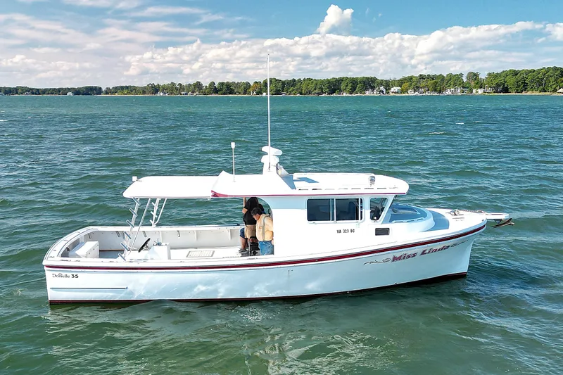 Slide: The Image of 2002 Donelle Express Down East Lobster Boat cruising on a scenic lake. - 31