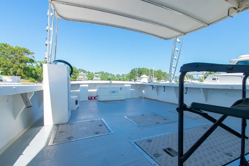 Slide: The Image of 2002 Donelle Express Down East Lobster Boat interior with open deck and seating. - 20