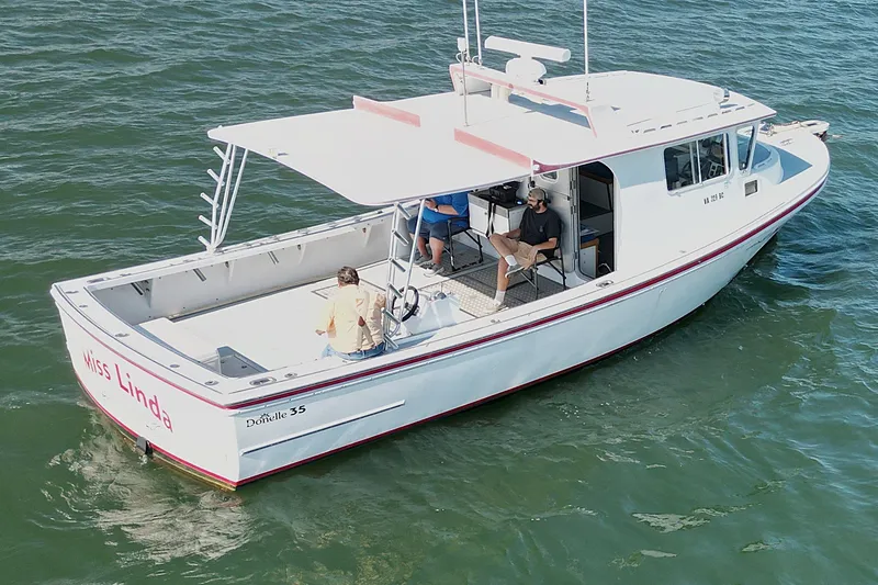 Slide: The Image of 2002 Donelle Express Down East Lobster Boat on water, named "Miss Linda." - 33