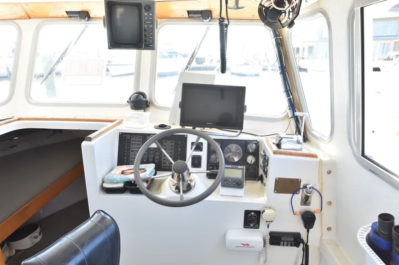 Slide: The Image of Interior of 2002 Donelle Express Down East Lobster Boat cockpit with navigation equipment. - 2
