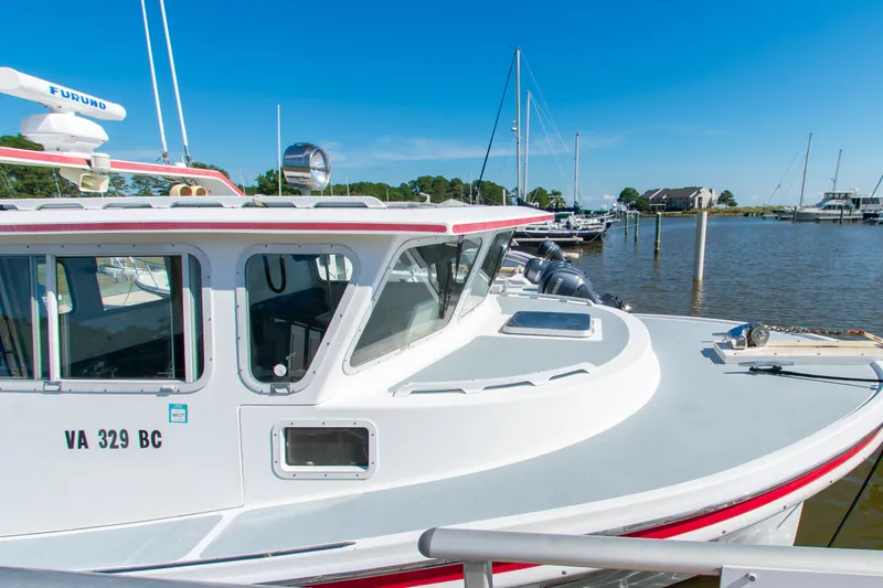 Slide: The Image of 2002 Donelle Express Down East Lobster Boat docked at a marina under clear blue skies. - 39