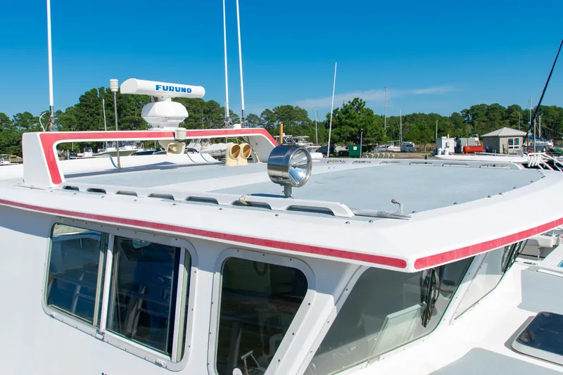 Slide: The Image of 2002 Donelle Express Down East Lobster Boat with radar, docked under clear blue sky. - 38
