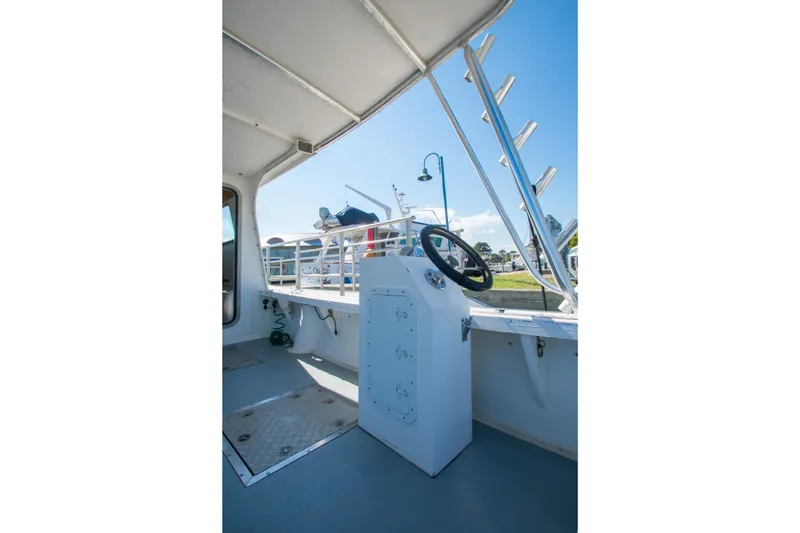 Slide: The Image of 2002 Donelle Express Down East Lobster Boat interior with steering wheel and open deck view. - 26