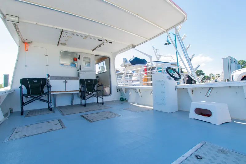 Slide: The Image of Interior of 2002 Donelle Express Down East Lobster Boat with seating and steering wheel. - 22