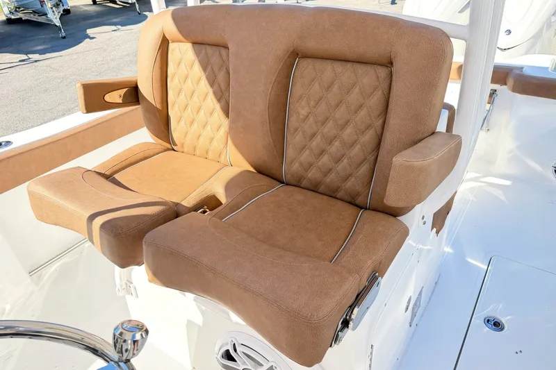 Slide: The Image of Luxurious seating on 2025 Sea Hunt Gamefish 30FS boat, featuring tan upholstery and diamond stitching. - 13