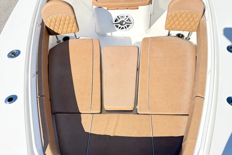 Slide: The Image of 2025 Sea Hunt Gamefish 30FS boat interior with tan cushioned seating and speaker system. - 28