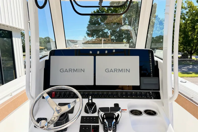 Slide: The Image of 2025 Sea Hunt Gamefish 30FS helm with dual Garmin displays and modern controls. - 22