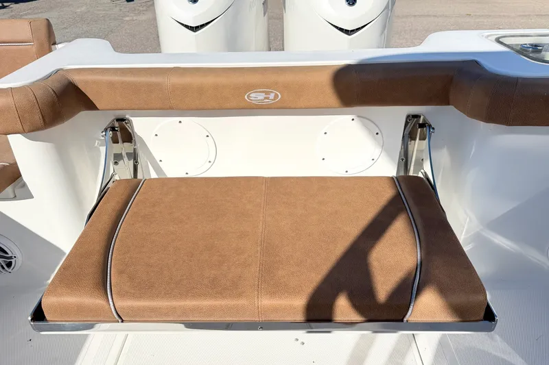 Slide: The Image of 2025 Sea Hunt Gamefish 30FS boat with brown cushioned seating and sleek design. - 11