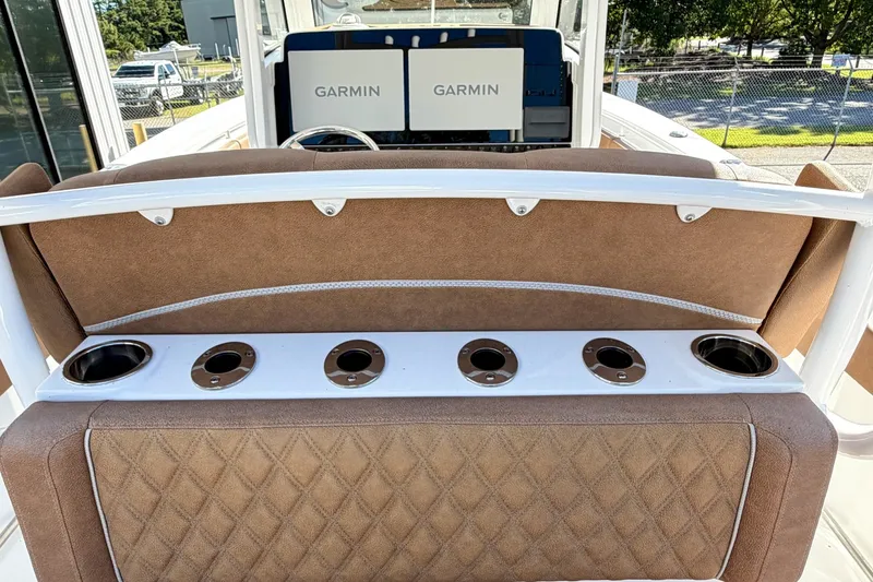 Slide: The Image of 2025 Sea Hunt Gamefish 30FS boat interior with Garmin displays and cup holders. - 19