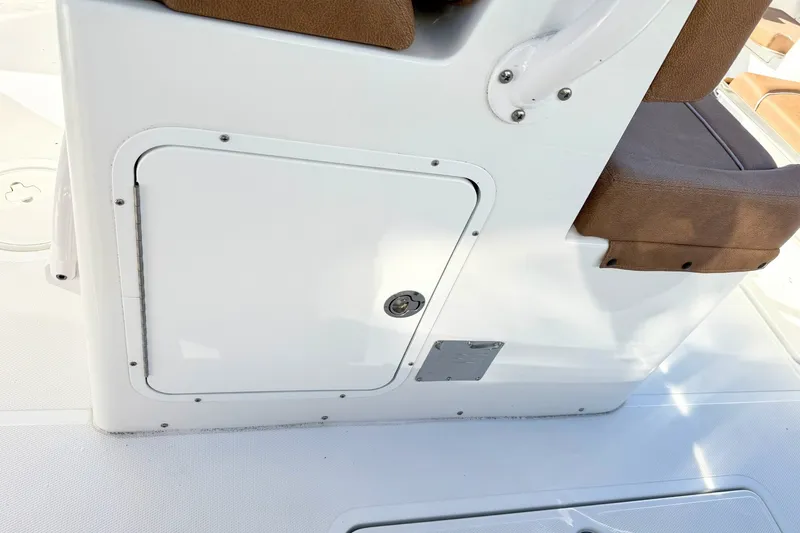 Slide: The Image of 2025 Sea Hunt Gamefish 30FS boat interior with storage compartment and seating. - 15