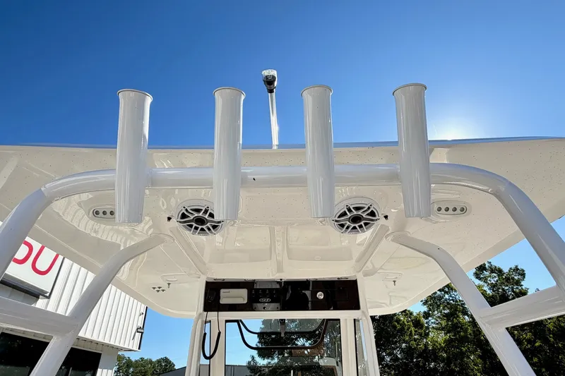 Slide: The Image of 2025 Sea Hunt Gamefish 30FS boat with rod holders and speakers under a clear blue sky. - 20