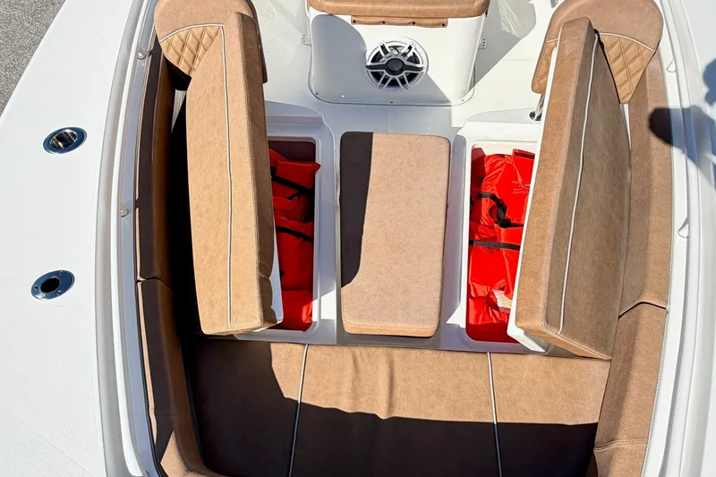 Slide: The Image of 2025 Sea Hunt Gamefish 30FS boat interior with tan seating and storage compartments. - 29