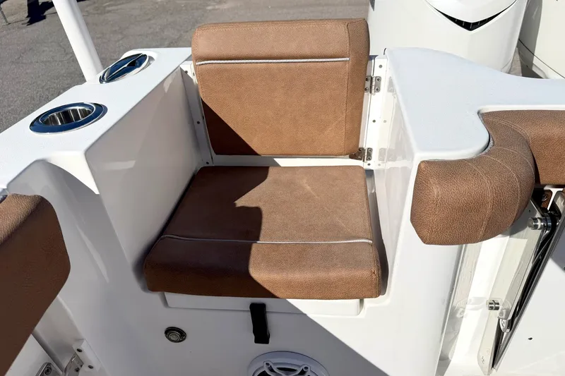 Slide: The Image of 2025 Sea Hunt Gamefish 30FS boat seat with brown cushions and cup holders. - 8
