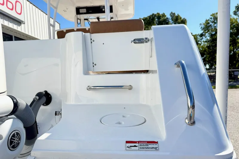 Slide: The Image of 2025 Sea Hunt Gamefish 30FS boat deck with stainless steel handles and Yamaha engine. - 2