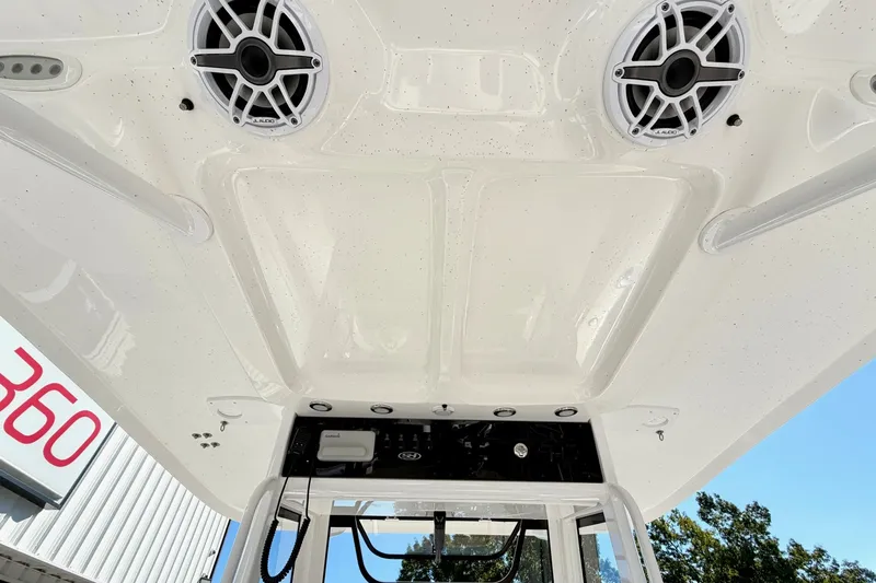 Slide: The Image of 2025 Sea Hunt Gamefish 30FS boat interior ceiling with speakers and control panel. - 21
