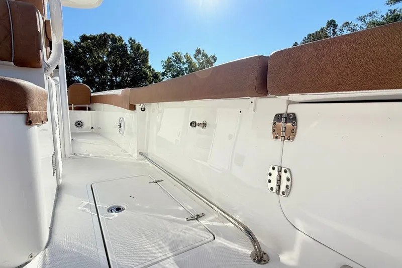 Slide: The Image of 2025 Sea Hunt Gamefish 30FS boat interior with cushioned seating and storage compartments. - 4