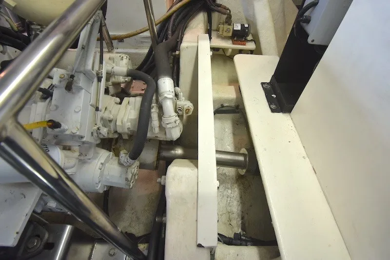 Slide: The Image of Engine room of 2004 Ocean Alexander 58 Pilothouse yacht, showcasing mechanical components and piping. - 50