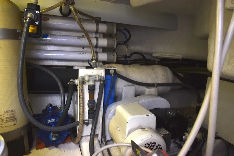 Slide: The Image of Engine room of 2004 Ocean Alexander 58 Pilothouse yacht, showcasing mechanical components and piping. - 37