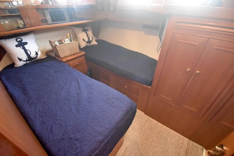 Slide: The Image of Cozy cabin with twin beds and nautical decor on a 2004 Ocean Alexander 58 Pilothouse yacht. - 19