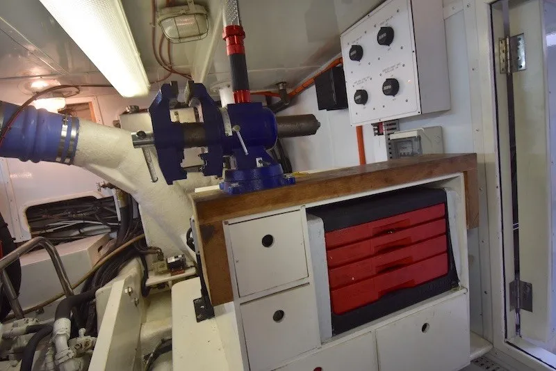 Slide: The Image of Engine room of 2004 Ocean Alexander 58 Pilothouse with workbench and tool storage. - 48