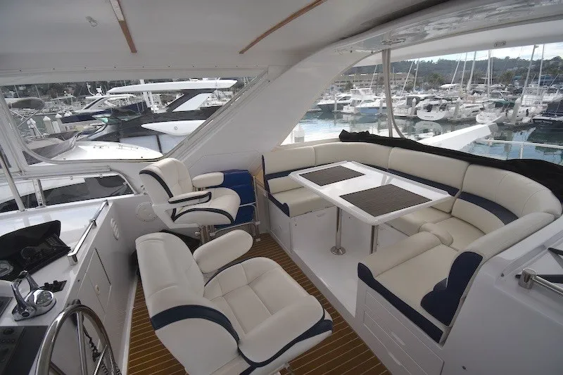 Slide: The Image of Luxurious 2004 Ocean Alexander 58 Pilothouse yacht interior with plush seating and marina view. - 29