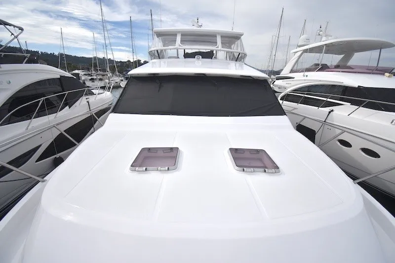Slide: The Image of 2004 Ocean Alexander 58 Pilothouse yacht docked at marina, showcasing sleek design and spacious deck. - 35