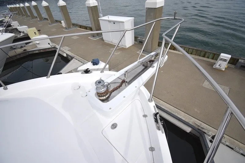 Slide: The Image of 2004 Ocean Alexander 58 Pilothouse yacht docked, showcasing bow and anchor chain. - 36