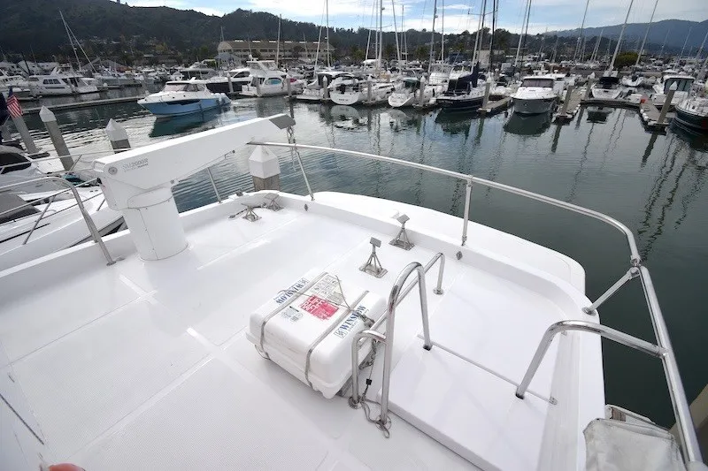 Slide: The Image of 2004 Ocean Alexander 58 Pilothouse yacht deck overlooking marina with numerous boats docked. - 32