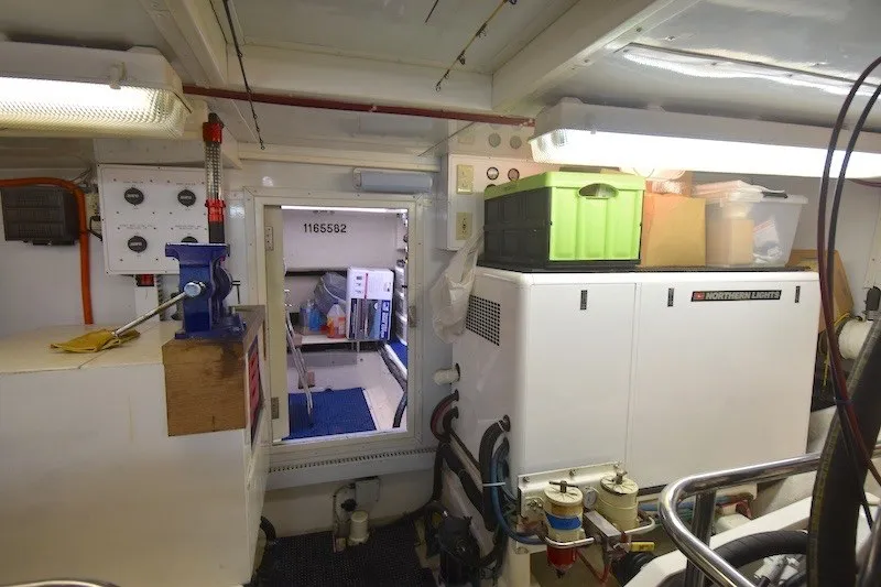 Slide: The Image of Engine room of 2004 Ocean Alexander 58 Pilothouse yacht, featuring equipment and storage. - 47
