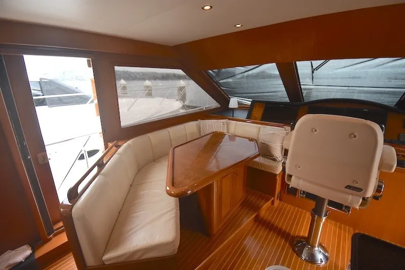 Slide: The Image of Luxurious interior of 2004 Ocean Alexander 58 Pilothouse yacht with elegant seating and helm. - 12