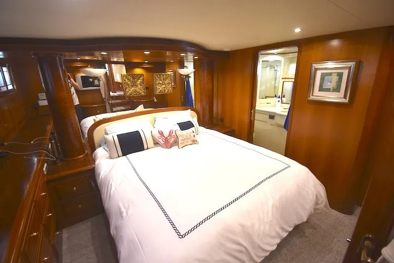 Slide: The Image of Luxurious bedroom interior of 2004 Ocean Alexander 58 Pilothouse yacht with elegant wood finishes. - 23