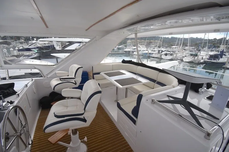 Slide: The Image of Luxurious 2004 Ocean Alexander 58 Pilothouse yacht interior with plush seating and marina view. - 28