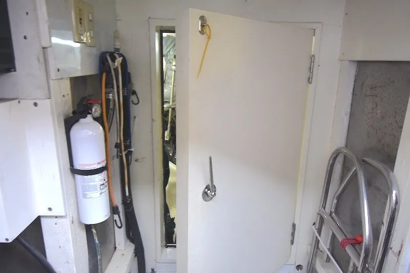 Slide: The Image of Engine room access on 2004 Ocean Alexander 58 Pilothouse yacht, featuring safety equipment. - 38