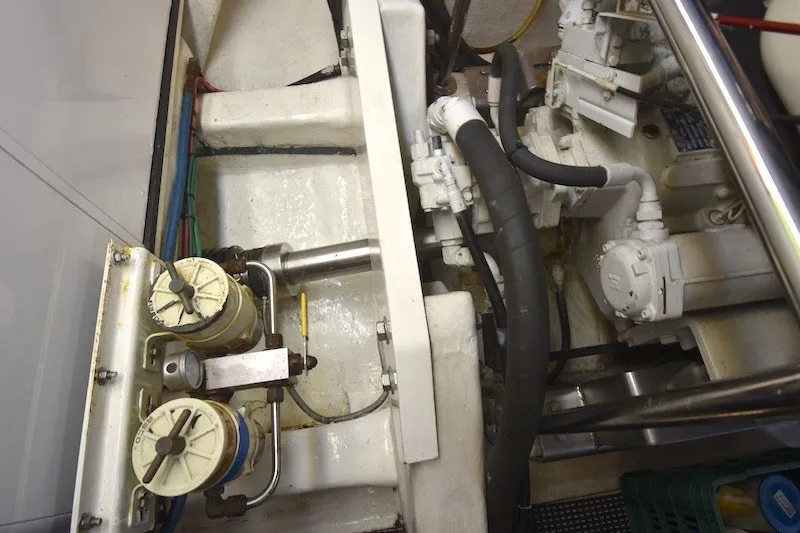 Slide: The Image of Engine room of 2004 Ocean Alexander 58 Pilothouse yacht, showcasing mechanical components and piping. - 49