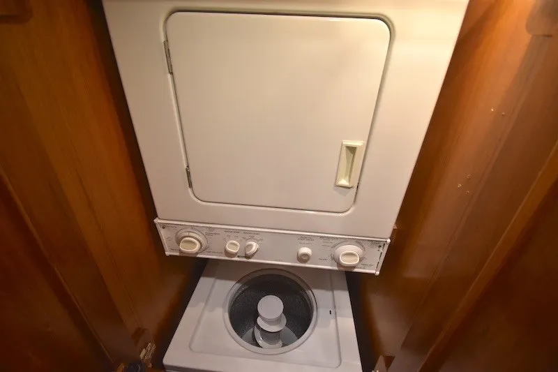 Slide: The Image of Stacked washer and dryer unit inside 2004 Ocean Alexander 58 Pilothouse yacht. - 24