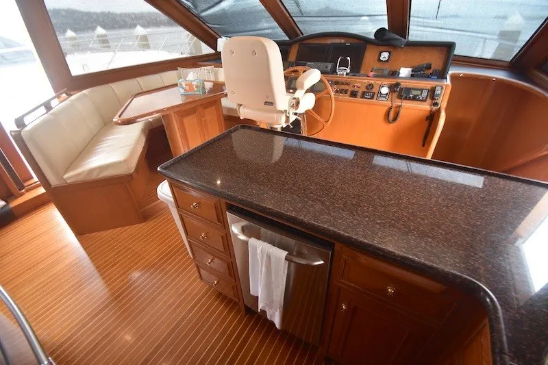 Slide: The Image of Luxurious 2004 Ocean Alexander 58 Pilothouse interior with helm, seating, and polished wood finishes. - 14