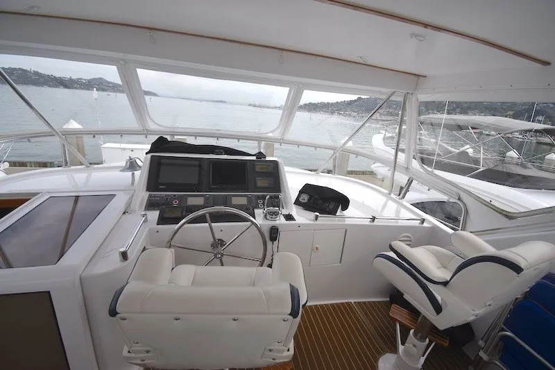 Slide: The Image of Pilothouse interior of 2004 Ocean Alexander 58 yacht with steering wheel and navigation equipment. - 30