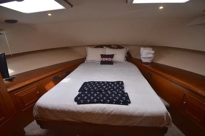 Slide: The Image of Luxurious bedroom in 2004 Ocean Alexander 58 Pilothouse yacht with cozy bedding and elegant wood finish. - 21