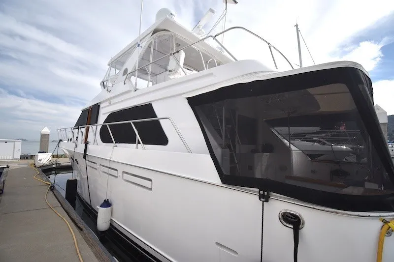 Slide: The Image of 2004 Ocean Alexander 58 Pilothouse yacht docked at marina under cloudy sky. - 3