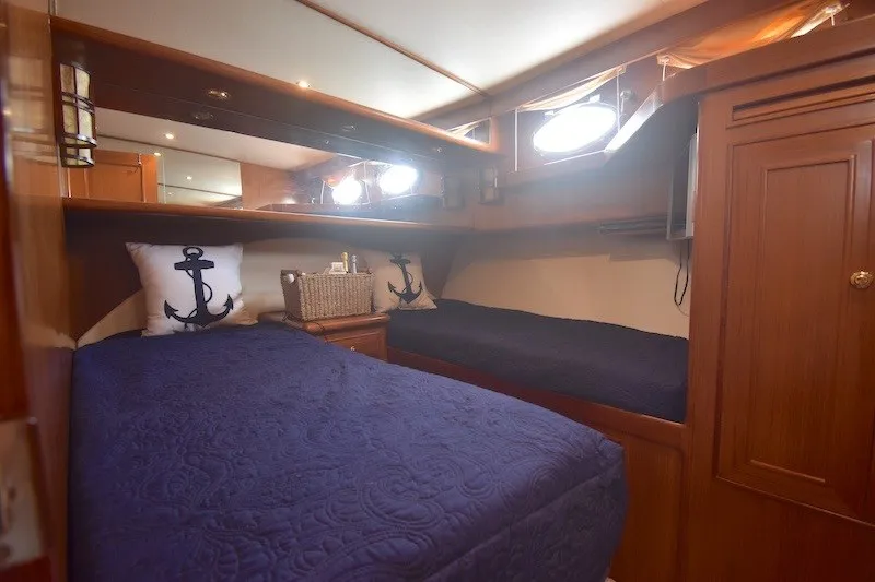 Slide: The Image of Luxurious 2004 Ocean Alexander 58 Pilothouse cabin with nautical decor and cozy bedding. - 18